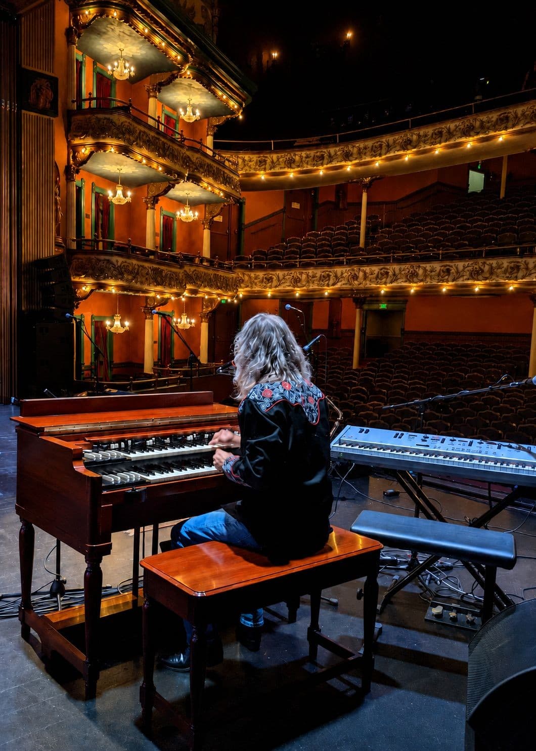Eddie Stone playing his vintage Hammond organ on the stage of an ornate historic opera house